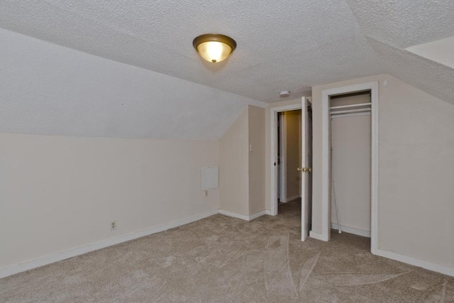 bonus room featuring baseboards, carpet flooring, lofted ceiling, and a textured ceiling