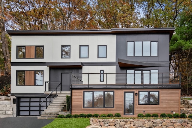 view of front of house featuring a garage and a balcony