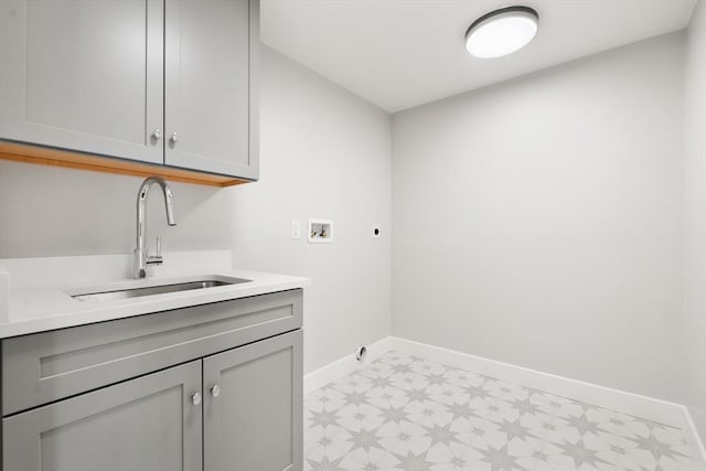 clothes washing area featuring sink, hookup for a washing machine, electric dryer hookup, and cabinets