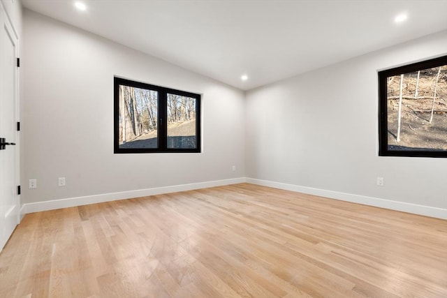 spare room featuring light hardwood / wood-style floors