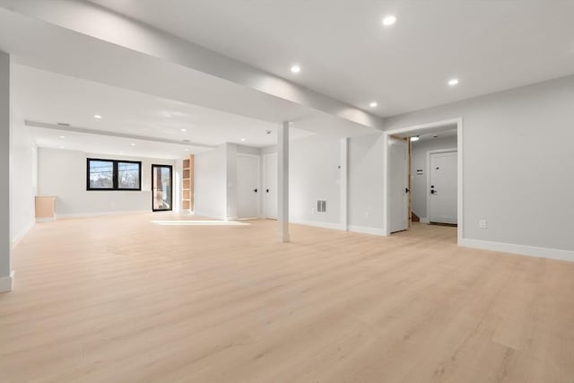 basement with light hardwood / wood-style floors