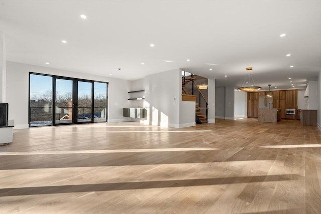 unfurnished living room featuring light wood-type flooring