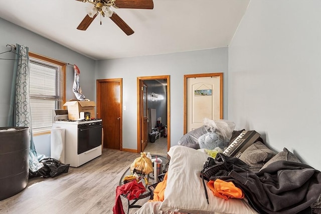 bedroom featuring baseboards, a ceiling fan, and light wood-style floors