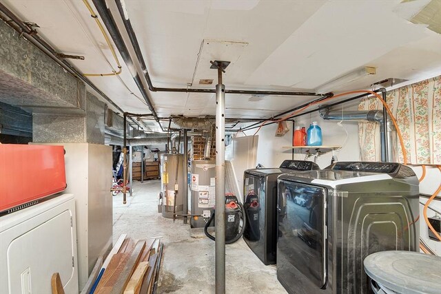unfinished basement featuring water heater and washing machine and dryer