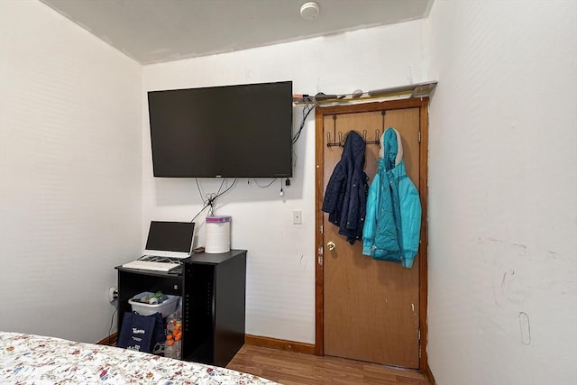 bedroom featuring wood finished floors and baseboards