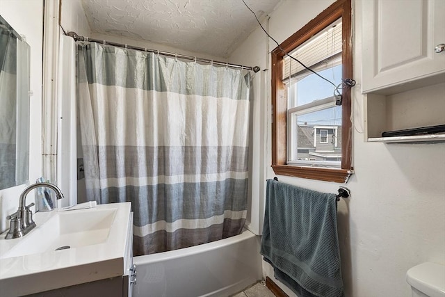 bathroom with a textured ceiling, vanity, toilet, and shower / bath combination with curtain