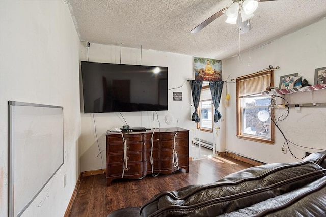 bedroom featuring a textured ceiling, wood finished floors, a ceiling fan, and a baseboard radiator
