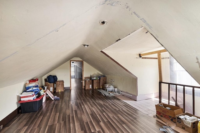 additional living space with wood finished floors and baseboards