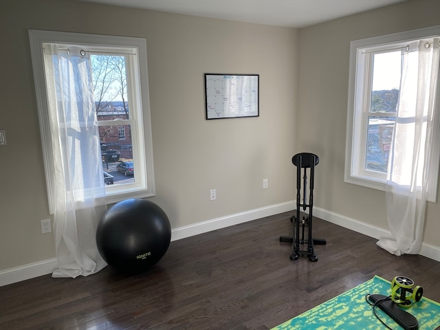 exercise room with a healthy amount of sunlight and dark wood-type flooring