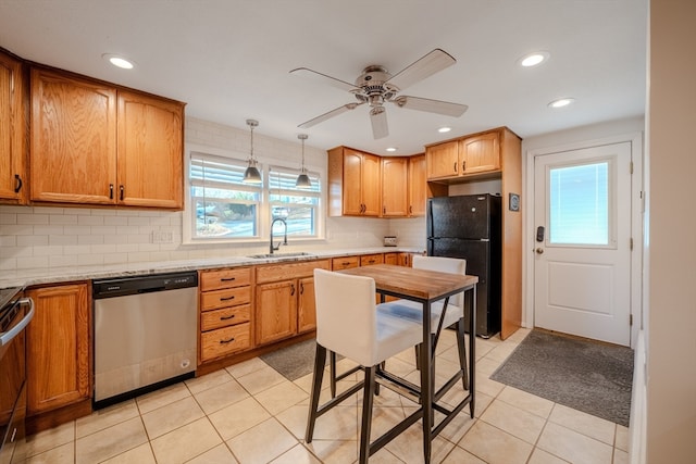 kitchen with light tile patterned floors, stainless steel appliances, a wealth of natural light, and sink