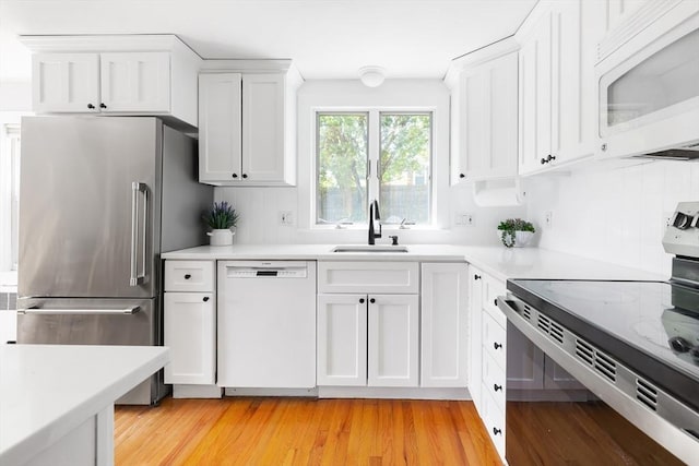 273 Greendale Ave, Needham, MA 02494 - kitchen featuring white appliances, a sink, white cabinetry, and light countertops