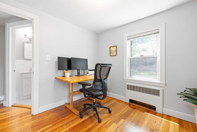273 Greendale Ave, Needham, MA 02494 - home office featuring radiator, light wood finished floors, and baseboards