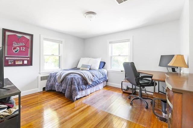273 Greendale Ave, Needham, MA 02494 - bedroom with radiator, multiple windows, hardwood / wood-style flooring, and baseboards