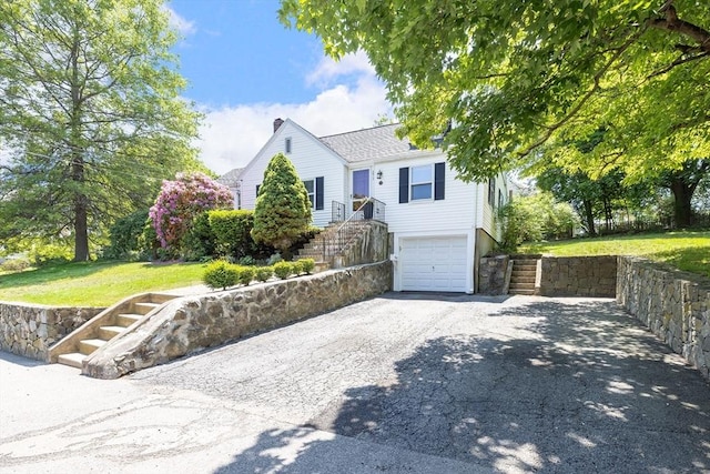 273 Greendale Ave, Needham, MA 02494 - view of front of home with an attached garage, driveway, a front lawn, and stairs