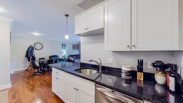 1100 Vfw Pkwy Unit 202, Boston, MA 02132 - kitchen featuring a sink, stainless steel dishwasher, crown molding, white cabinets, and hanging light fixtures