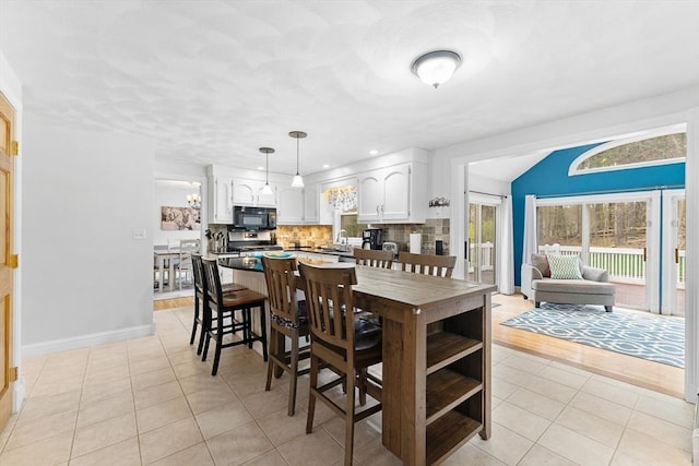 dining space with recessed lighting, baseboards, and light tile patterned floors