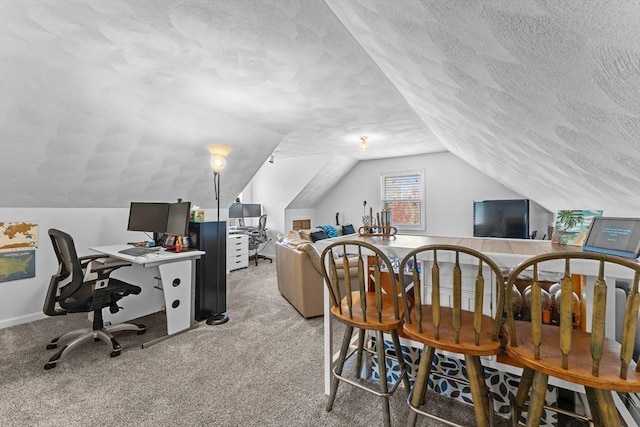 home office featuring a textured ceiling, light colored carpet, and vaulted ceiling