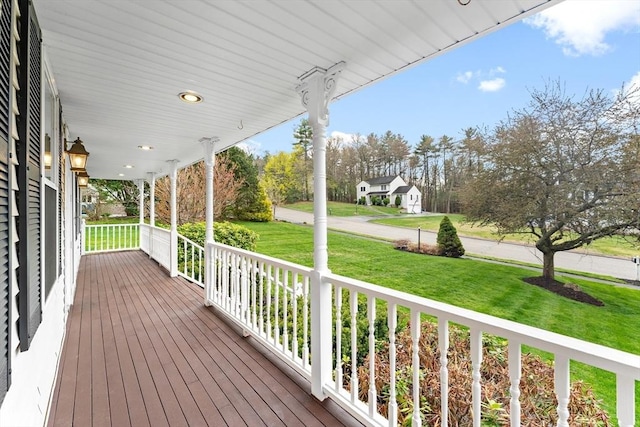 deck with covered porch and a yard