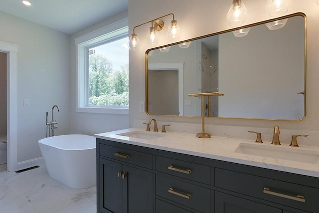 12 Willow St, Pepperell, MA 01463 - bathroom featuring double vanity, a freestanding tub, and marble finish flooring