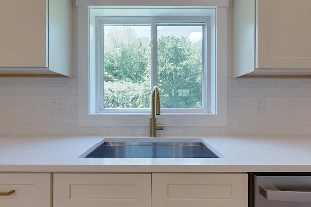 12 Willow St, Pepperell, MA 01463 - kitchen with a sink, white cabinetry, and tasteful backsplash