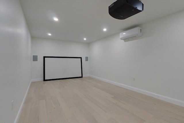 12 Willow St, Pepperell, MA 01463 - cinema room featuring a wall unit AC, recessed lighting, light wood finished floors, and baseboards