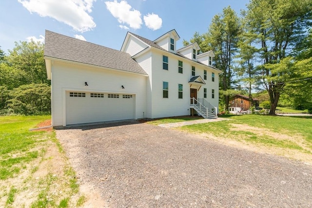 12 Willow St, Pepperell, MA 01463 - view of front facade with driveway and a garage