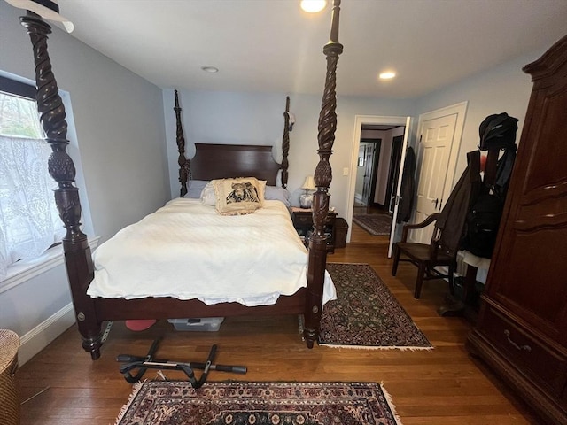 bedroom with wood finished floors, recessed lighting, and baseboards