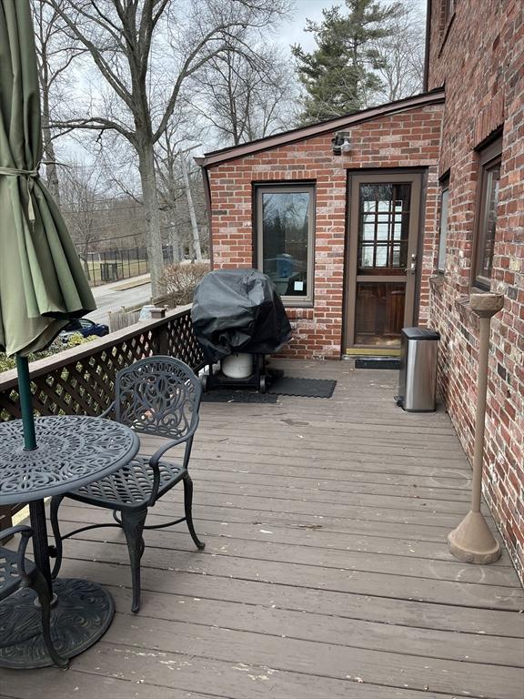 wooden deck featuring grilling area and outdoor dining space