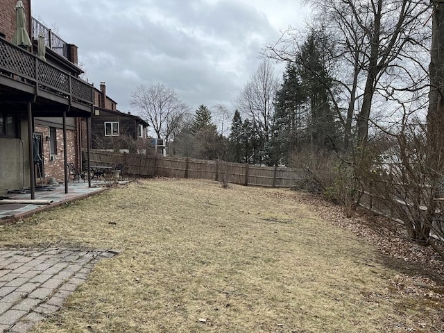 view of yard featuring a patio and a balcony