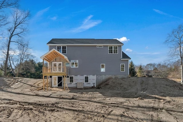 rear view of house featuring a deck