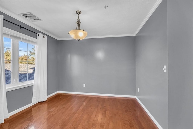 unfurnished room with hardwood / wood-style floors and crown molding