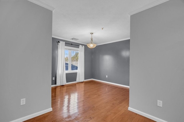 unfurnished room with wood-type flooring and ornamental molding