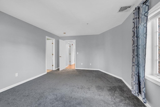 empty room featuring carpet flooring and a healthy amount of sunlight