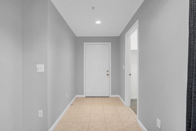 hallway featuring crown molding and light tile patterned flooring