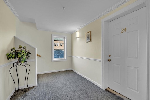 entryway with dark carpet and ornamental molding