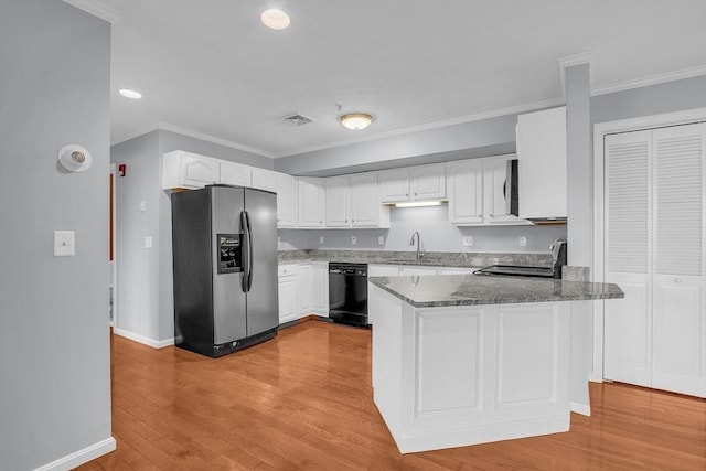 kitchen with white cabinets, stainless steel appliances, kitchen peninsula, and light hardwood / wood-style floors