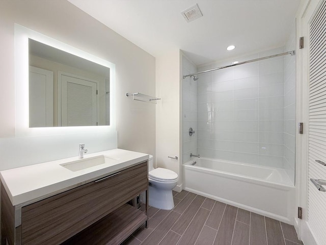 full bathroom featuring toilet, vanity, shower / washtub combination, recessed lighting, and wood finish floors