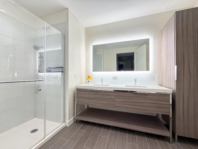 full bathroom with a stall shower, double vanity, and wood tiled floors