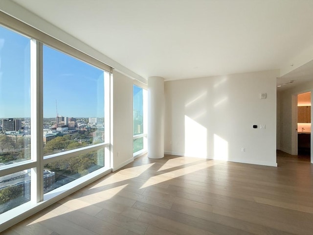 empty room with wood finished floors and baseboards