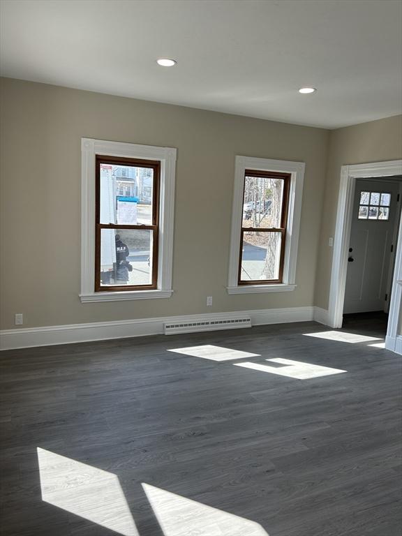 foyer entrance with recessed lighting, baseboards, baseboard heating, and dark wood finished floors