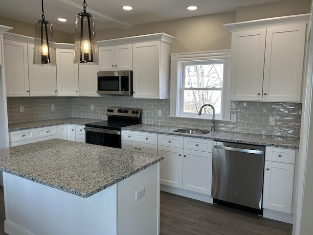 kitchen with a sink, stainless steel appliances, and white cabinets