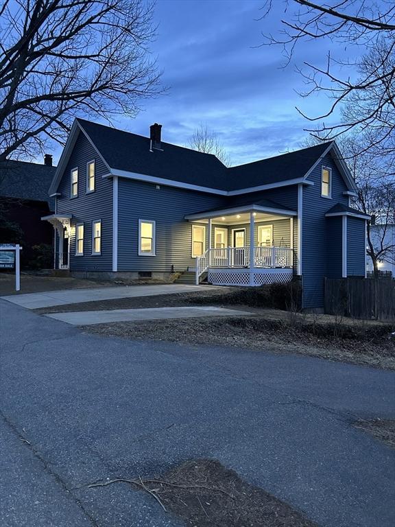 view of front of house featuring a porch and a chimney