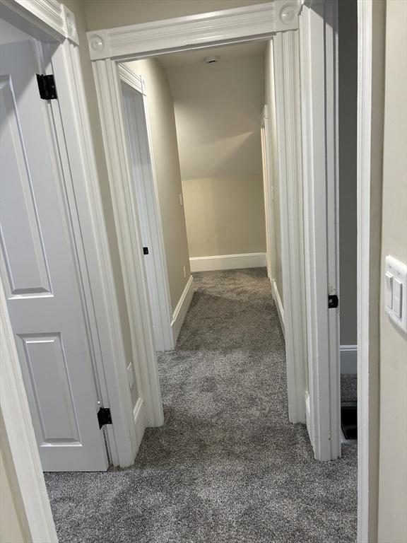 hall with carpet and baseboards