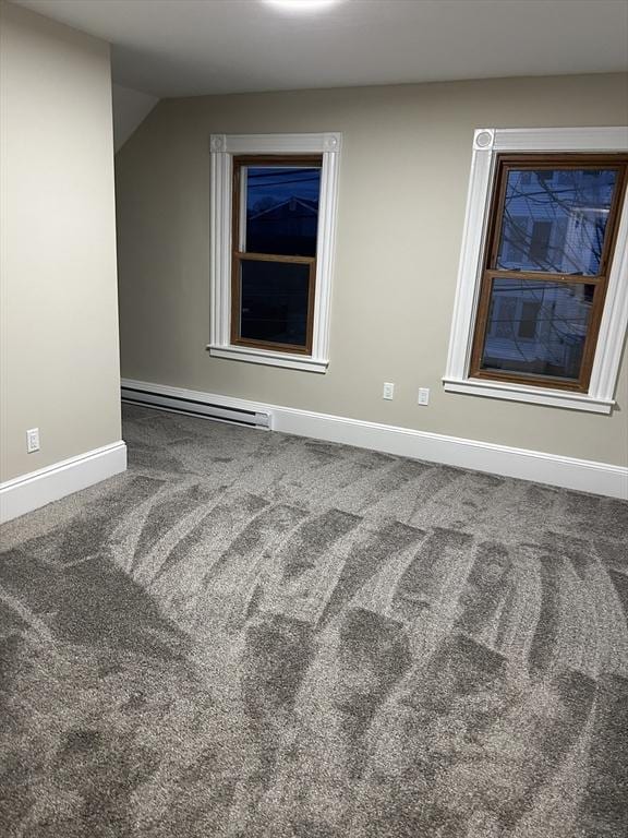 spare room featuring baseboards, carpet floors, and baseboard heating