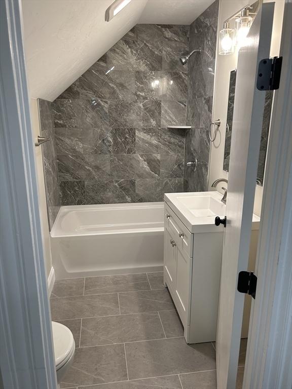 full bathroom with toilet, vanity, and shower / bathtub combination