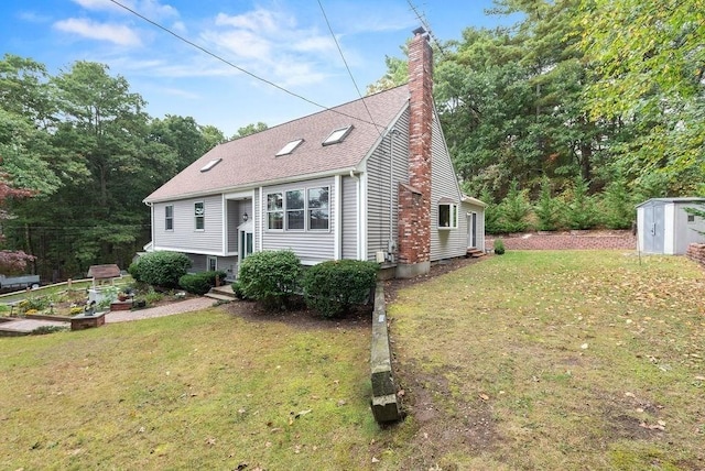 525 Thurston St, Wrentham, MA 02093 - view of front of home with a garden, a chimney, a front yard, and entry steps