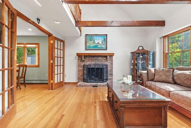 525 Thurston St, Wrentham, MA 02093 - living room with a baseboard heating unit, light wood-style floors, beamed ceiling, plenty of natural light, and a brick fireplace