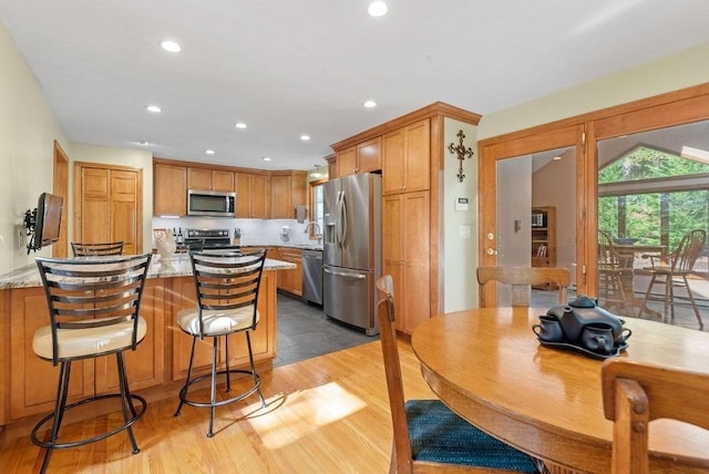 525 Thurston St, Wrentham, MA 02093 - kitchen with stainless steel appliances, a peninsula, light wood-type flooring, a sink, and recessed lighting