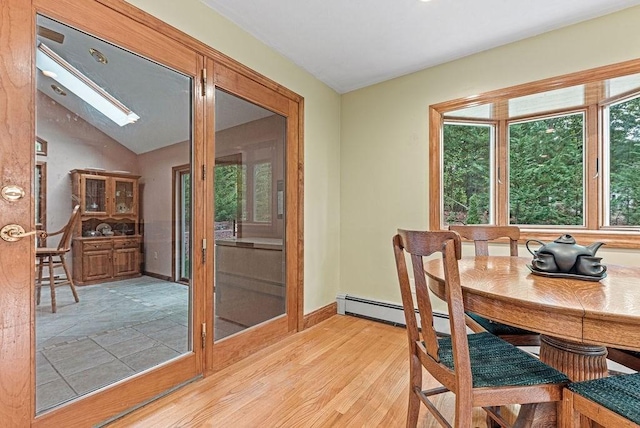 525 Thurston St, Wrentham, MA 02093 - dining space with a skylight, light wood-style flooring, baseboards, and lofted ceiling