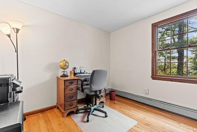 525 Thurston St, Wrentham, MA 02093 - home office featuring a baseboard heating unit, light wood-style flooring, and baseboards